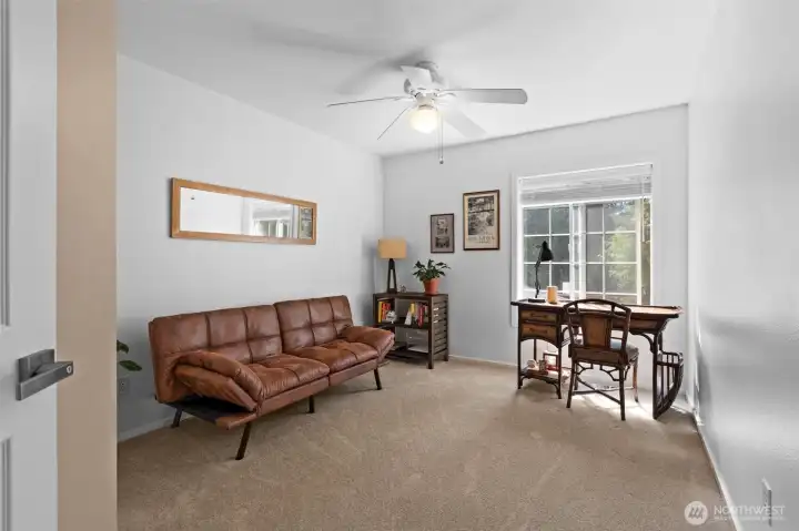 Versatile upstairs room features large window, ceiling fan, and abundant natural light. Versatile upstairs room features large window, ceiling fan, and abundant natural light.