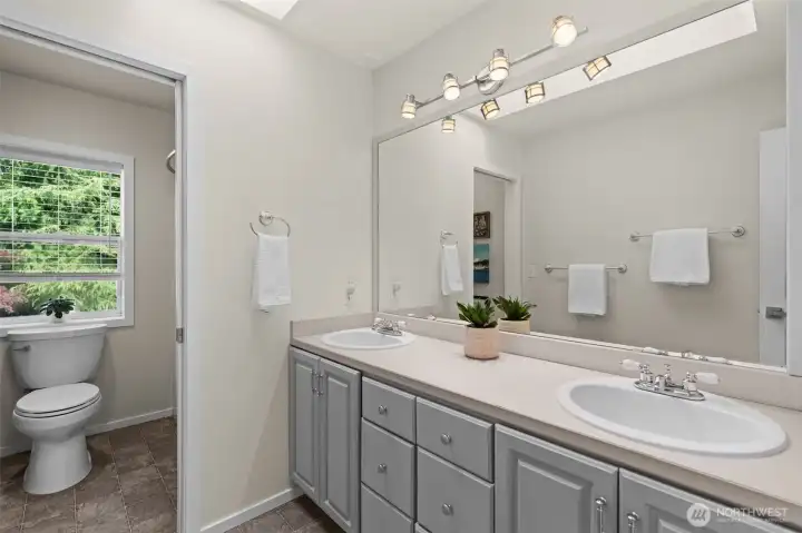 Bright bathroom with extended vanity space, abundant cabinetry, and functional layout. Bright bathroom with extended vanity space, abundant cabinetry, and functional layout.