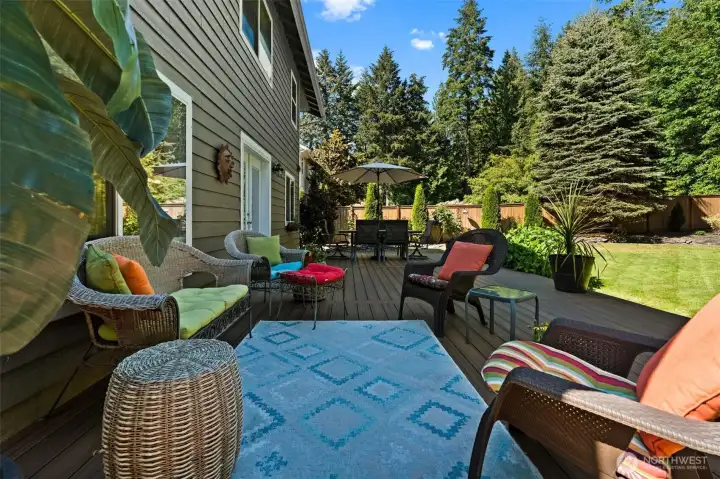 Large deck with dedicated spaces for dining and outdoor lounging. Large deck with dedicated spaces for dining and outdoor lounging.
