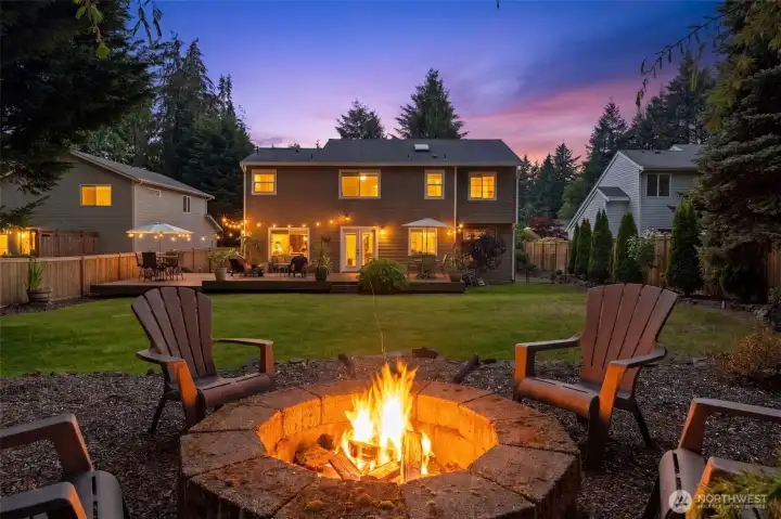 Backyard gathering area with built-in fire pit, expansive lawn, and views of the entertainment deck. Backyard gathering area with built-in fire pit, expansive lawn, and views of the entertainment deck.