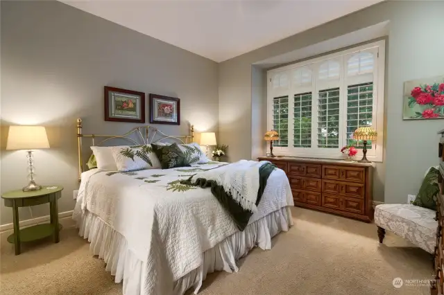 Bedroom #2 is located on the south end of the home and overlooks the front yard. It has a recessed area underneath the windows to maximize space. There is also custom cabinetry inside of the closet. Bedroom #2 adjoins a full bath with bedroom #3.