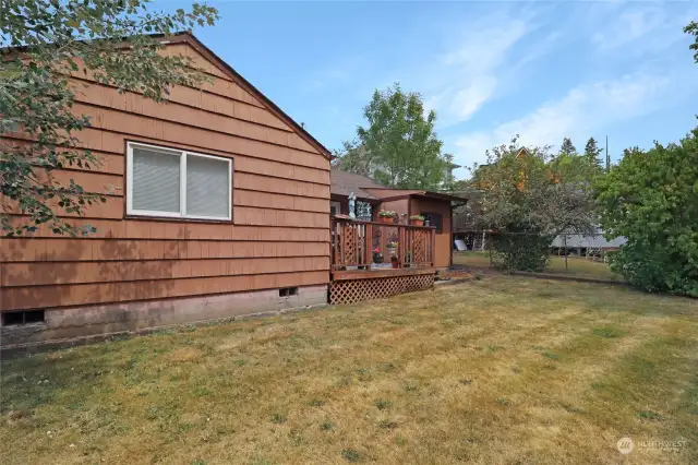 The fully fenced backyard offers privacy and security, complemented by a deck perfect for outdoor relaxation and entertainment.