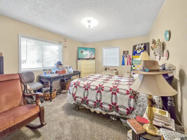 This is the larger of the two bedrooms, featuring a view of the backyard. It also has a nice sized closet, providing ample storage space while maintaining a cozy atmosphere