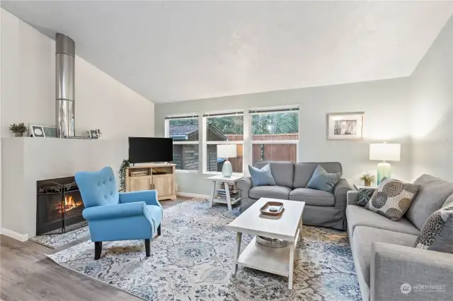 Living Room w/Wood Burning Fireplace, Windows for Natural Light and Vaulted Ceilings!