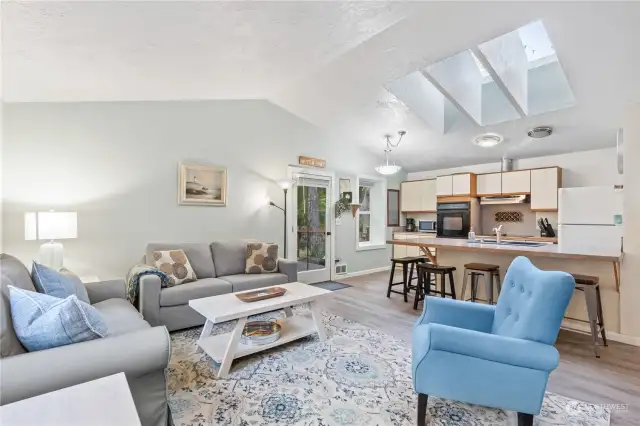 View looking toward the Kitchen. Notice the Vaulted Ceilings and Skylights!