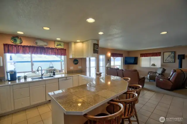 Breakfast bar and kitchen open onto a covered deck for entertaining rain or shine.