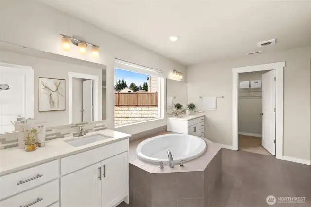 Spacious 5 piece primary bath is the place to be pampered.   Roomy walk-in closet is through the door.                                                                                                                                                  vrtually staged