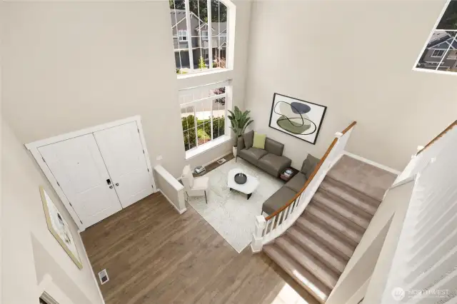 A stunning view overlooking the entry, living room and grand staircase.                                    virtually staged