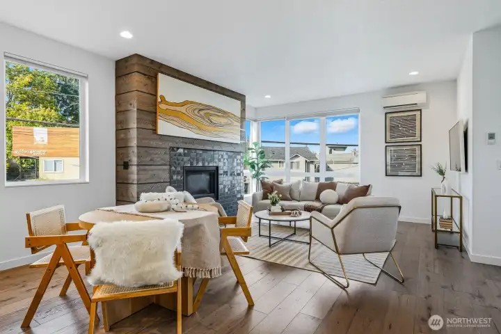 Natural light fills the room, while a gas fireplace anchors the space with warmth and charm.
