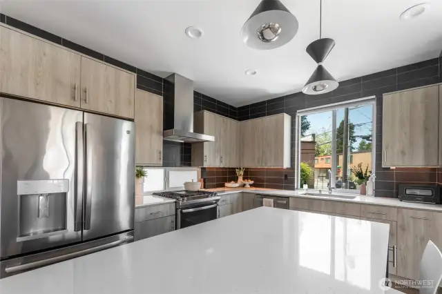 A large kitchen island and seamless countertops add to the kitchen’s undeniable allure.