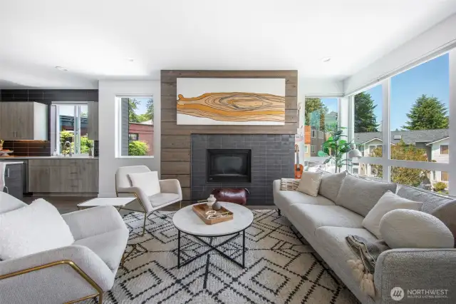 Natural light fills the room, while a gas fireplace anchors the space with warmth and charm.