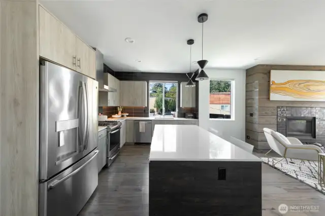A chef’s kitchen awaits—fully equipped with a gas range, oven, and built-in microwave—ready for you to craft your next culinary creation.
