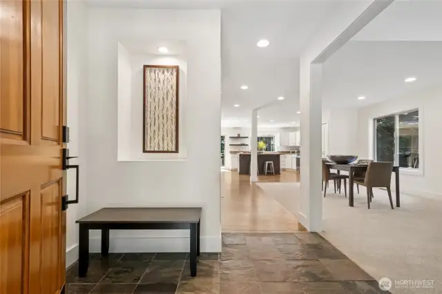 Stylish entry with stone slate tile and an art niche for a welcoming first impression.