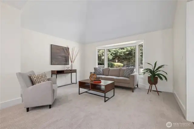 Vaulted ceilings elevate this refined living room just steps from the front door.