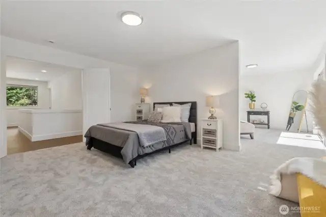 French doors open to a luxurious primary suite with adjoining sitting room and a peaceful balcony overlooking the lake.