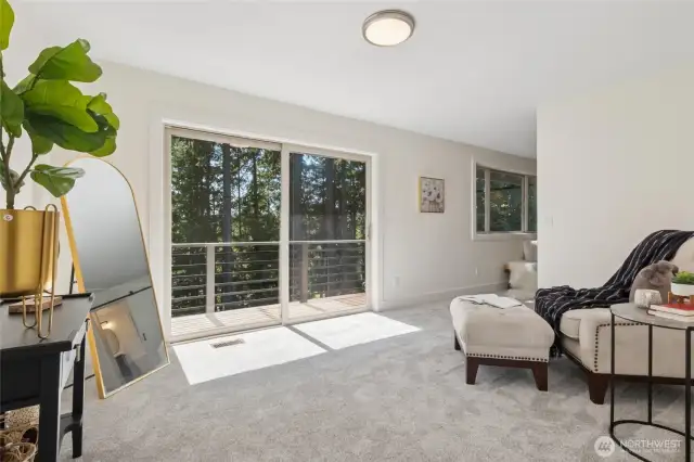 Private sitting area in the primary bedroom opens to a balcony, perfect for peaceful moments and serene views.