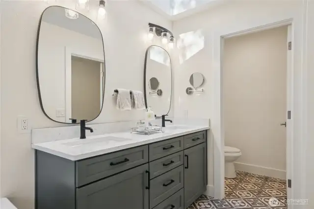 Chic double vanity complements the stylish ensuite design.