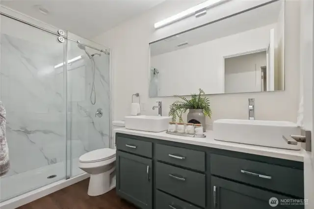 Refreshed and refined - stylish hall bathroom with a sliding glass shower door.