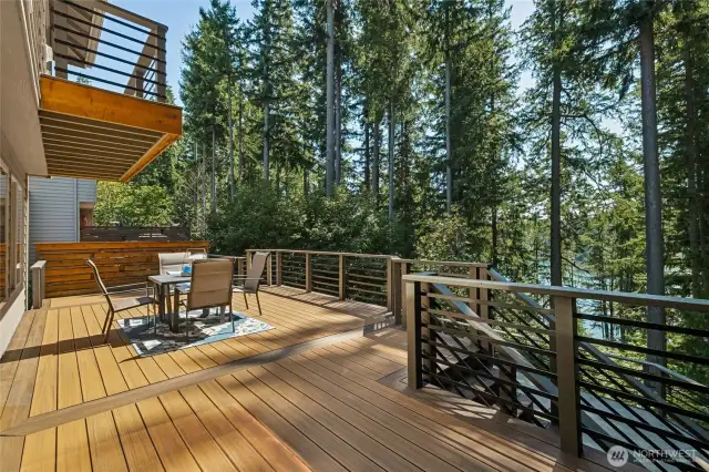 Relax or entertain on the main level deck with attractive railing, low-maintenance decking, hot tub ready, and views of the lake and nature.