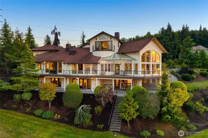 The waterside exterior showcases the all-encompassing deck and expansive windows that draw the outdoors in.  Large patios, covered and uncovered, on the ground level with the executive office perched as a Crow’s Nest.  An elevator connects you to each interior level.