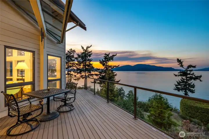 The deck wraps around three sides of the home allowing enjoyment of pink sunrises.  Suring spring and summer a cruise ship comes down the Channel headed to Cap Sante.