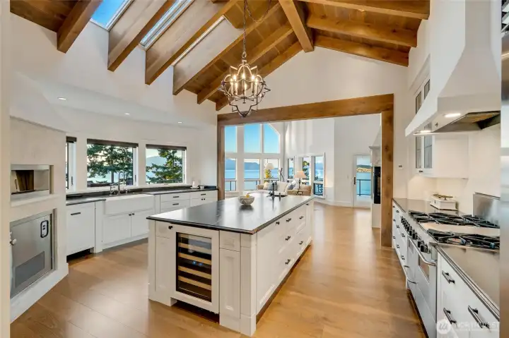 This kitchen flows effortlessly into open living spaces, designed for connection and entertaining against a backdrop of endless views.
