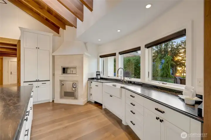 The kitchen includes a built-in commercial pizza oven that brings gourmet cooking into everyday living.  The kitchen also has a stunning view!