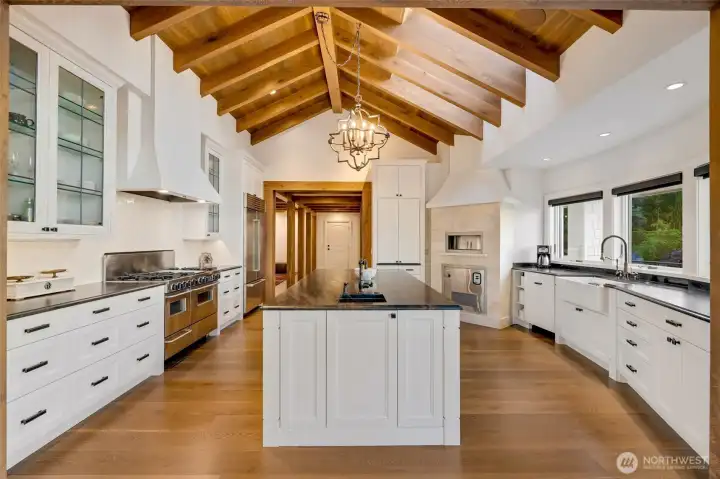 Luxe stone counters and integrated appliances pair with tailored cabinetry, creating a kitchen designed for both beauty and performance.