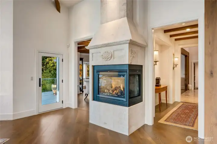 An imported Italian stone surround gives the family room fireplace presence and artistry, creating a striking focal point.  Note the detail in the custom surround.  All 8 fireplaces are natural gas.