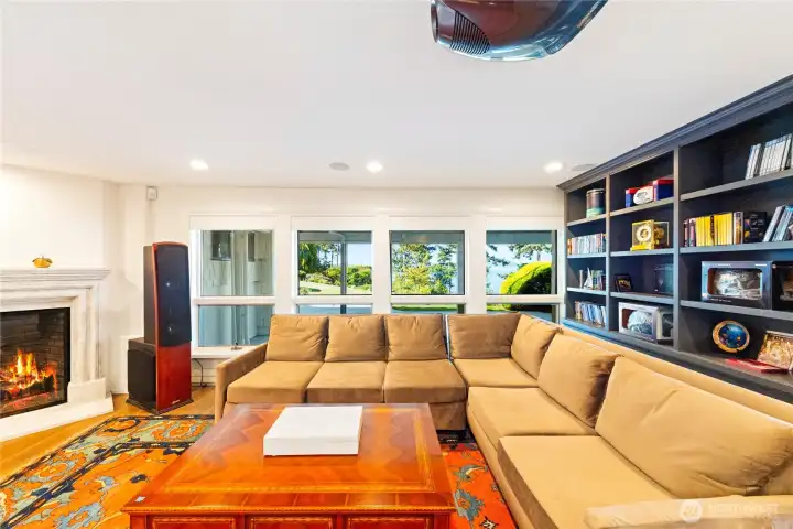 The media room’s gas fireplace adds warmth and atmosphere to evenings of film or entertainment.