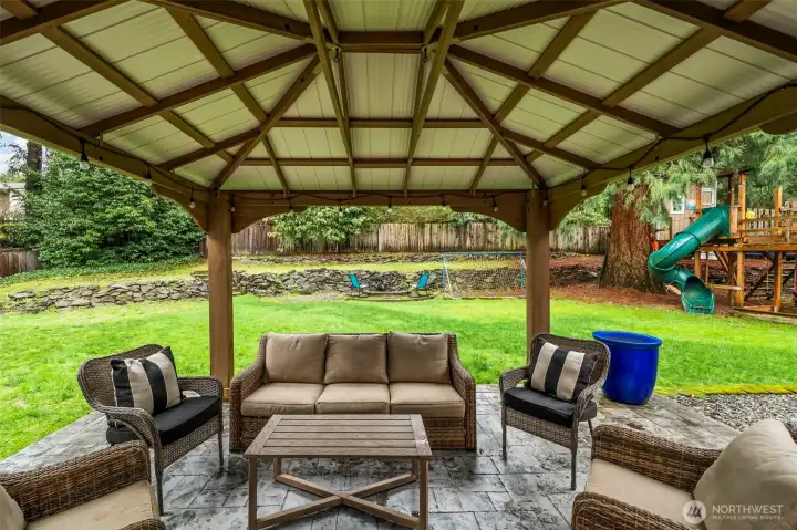 back yard patio with pergola for outdoor entertaining even in the rain. 13911 113th Ave Ct E, Puyallup, WA 98374