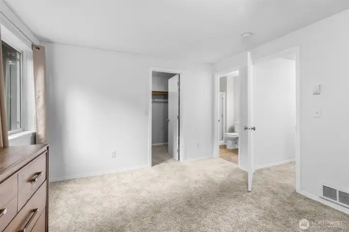 Light-filled primary bedroom with a spacious walk-in closet