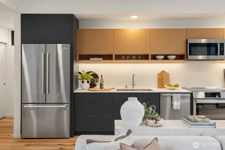 The gourmet kitchen boasts Abodian cabinetry, quartz counters and Bosch stainless steel Energy Star appliances.