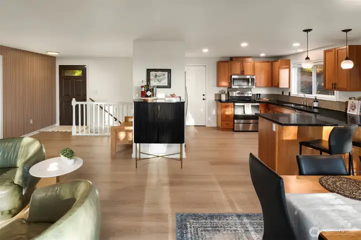 Spacious kitchen flows to dining and out to the deck with mountain views