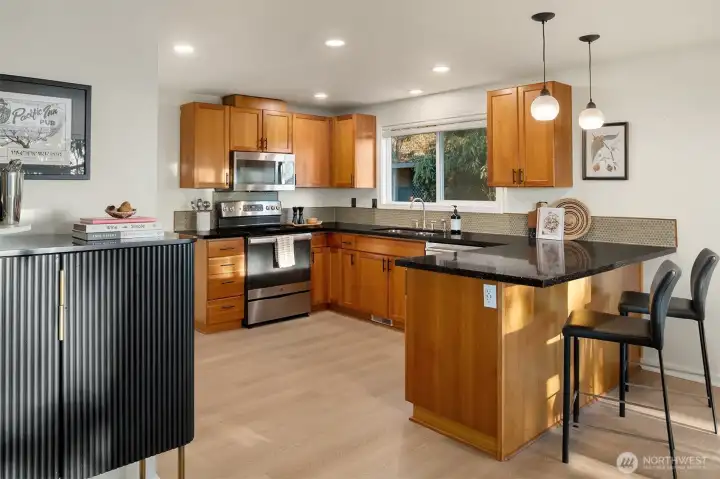 Spacious kitchen flows to dining and out to the deck with mountain views