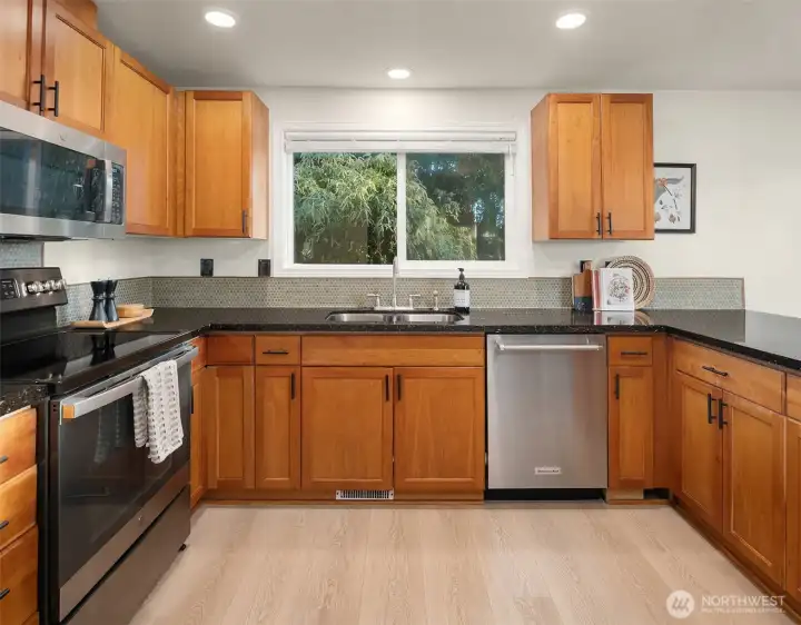 Spacious kitchen flows to dining and out to the deck with mountain views
