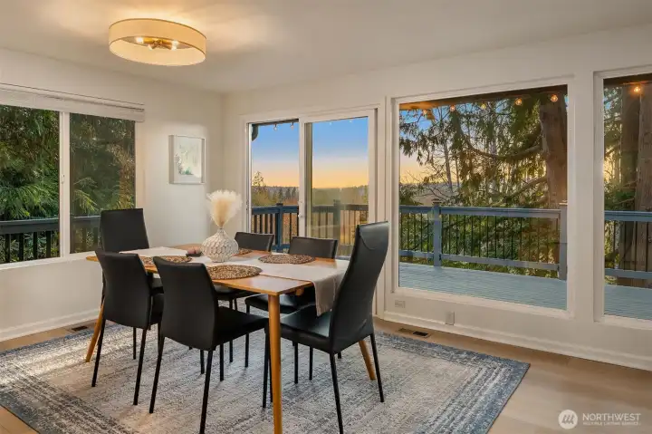 Spacious kitchen flows to dining and out to the deck with mountain views