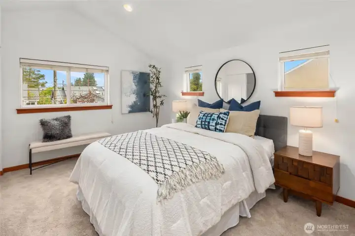 Picture windows bathe the large primary suite in natural light