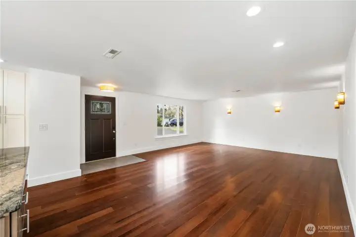 Spacious family room with dimmer sconces and a convenient coat closet by the tiled entryway.