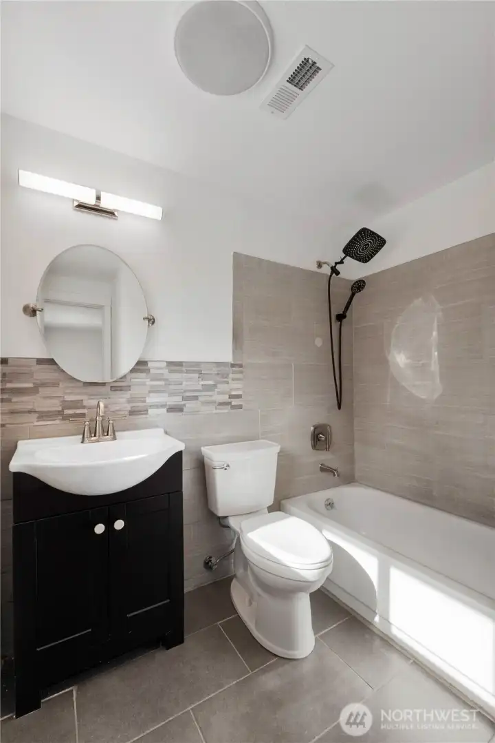 Tiled primary bathroom to wash your troubles away after a long day.