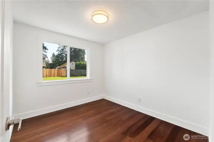 Third bedroom. Don't miss the craftsman wood trim, solid core doors and updated light fixtures throughout.