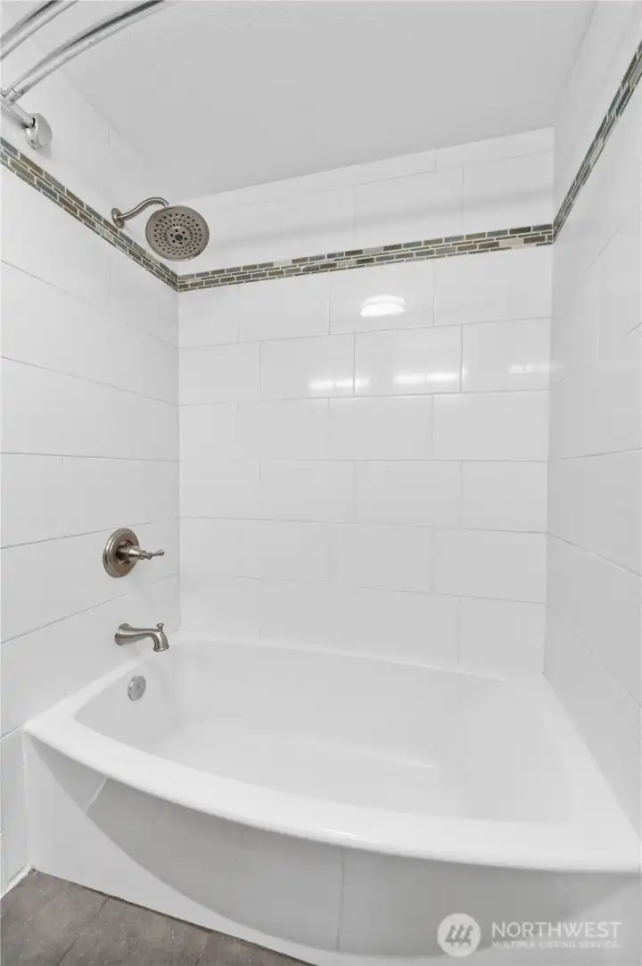 Guest bathroom also offers a tiled shower/tub combo.
