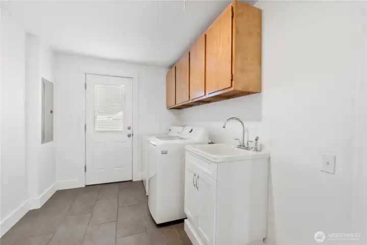Large laundry and mudroom with utility sink. All appliances are included.