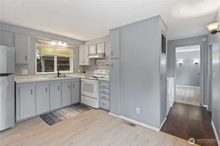 Another look from kitchen - Washer & Dryer in hallway toward primary bedroom.