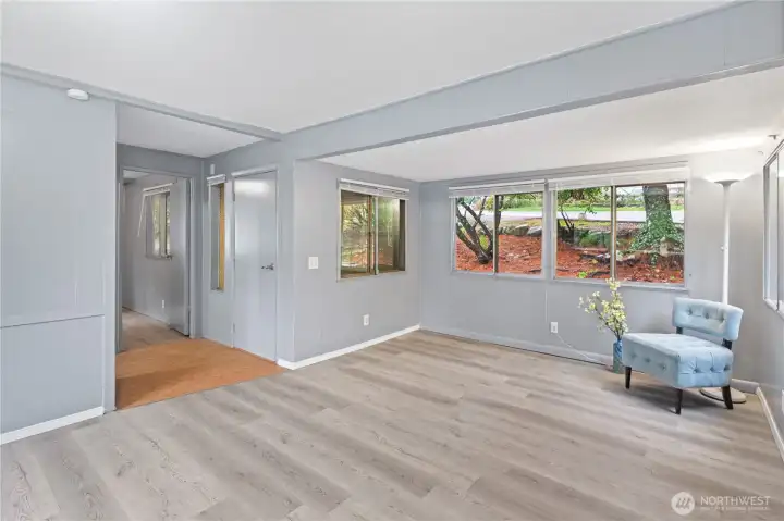 Front entrance opens into the living room with the second bedroom and bathroom nearby.
