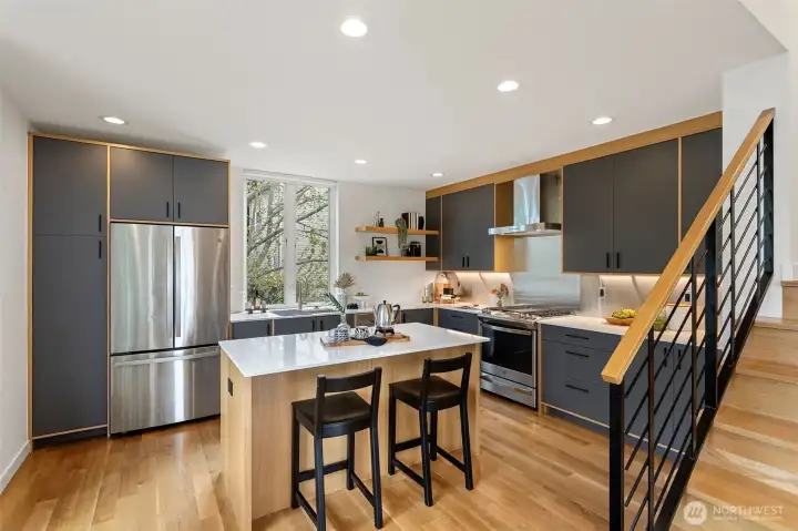 The kitchen Boasts Belmont modern cabinetry with deep drawers, pantry and pull outs.  There is a 24 gauge stainless steel backsplash.