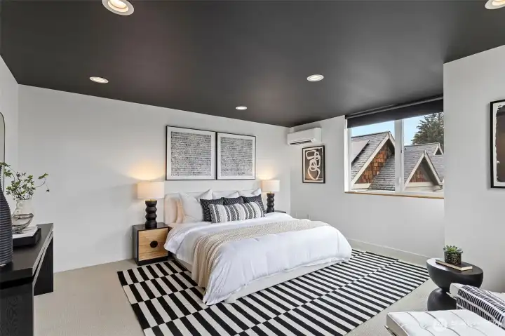 The primary bedroom ceiling is painted black for a dramatic design effect.