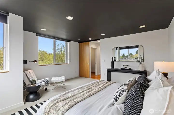 Both the primary bedroom and bathroom have solid oak sliding barn doors for added privacy.