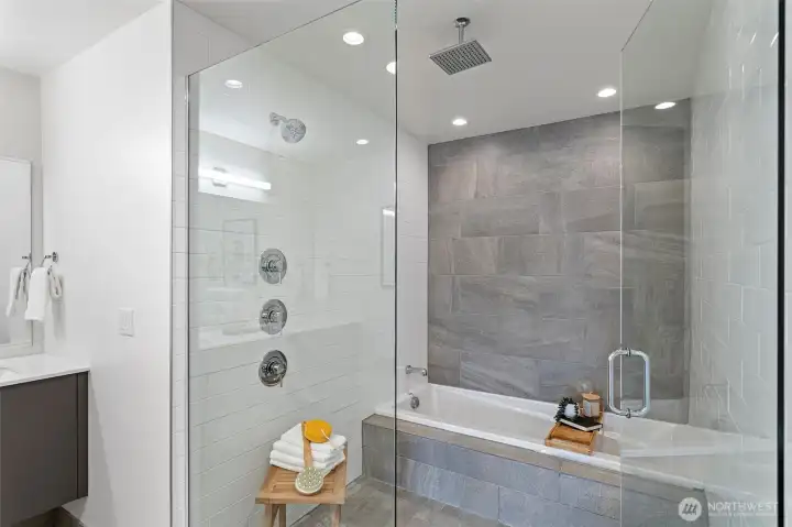 The inviting “Wet Room: has a deep soaking tub, spacious shower with rain showerhead and attractive ceramic and subway surround and flooring.