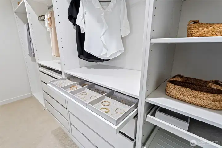 The walk-in closet also has a wall mounted full length mirror.